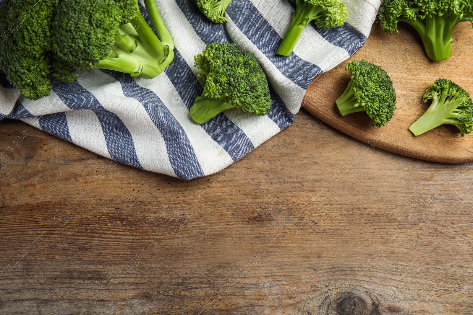 Fresh green broccoli on wooden table, flat lay. Space for text Photo of Fresh green broccoli on wooden table, flat lay. Space for text