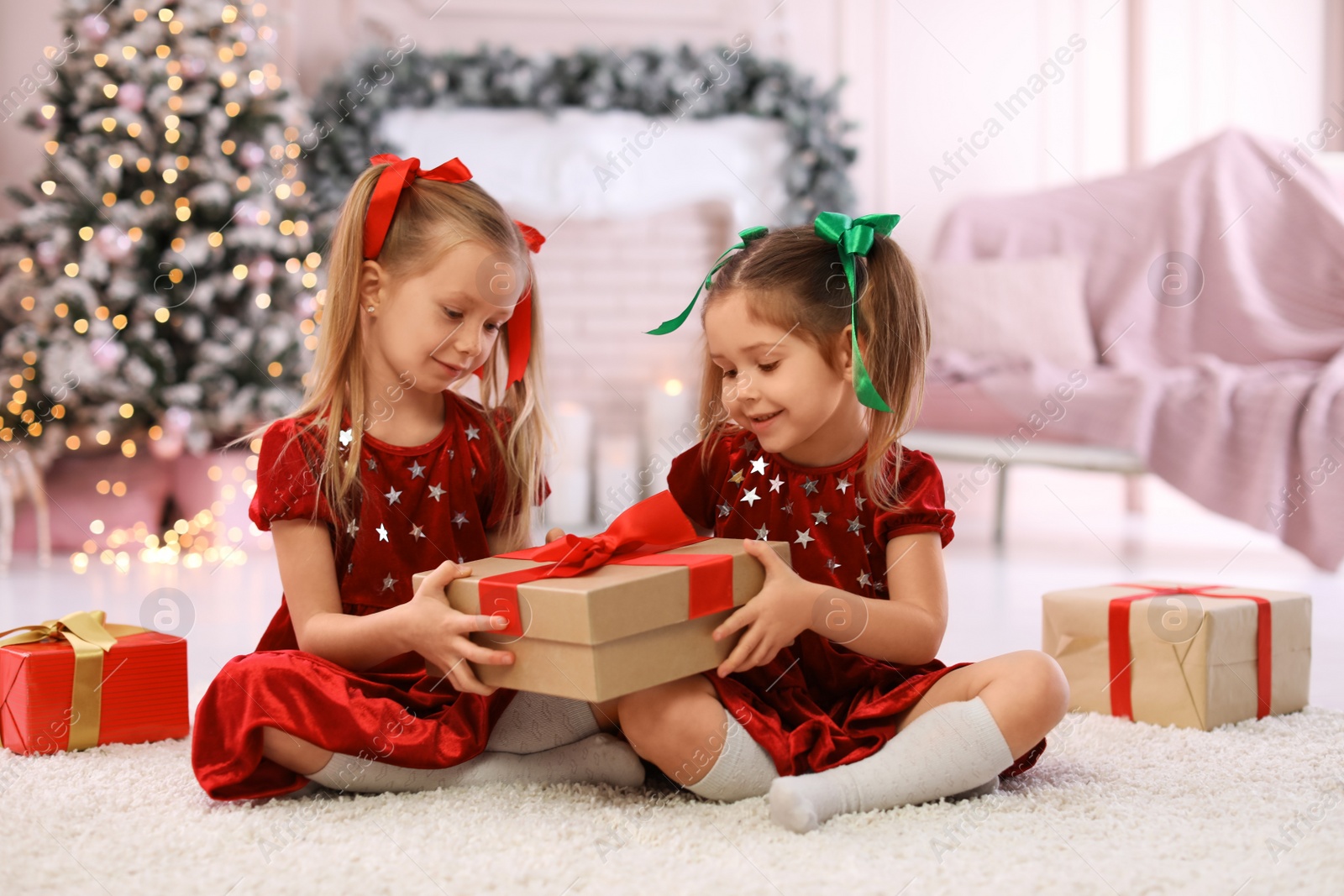 Cute little children with Christmas gifts at home Photo of Cute little children with Christmas gifts at home