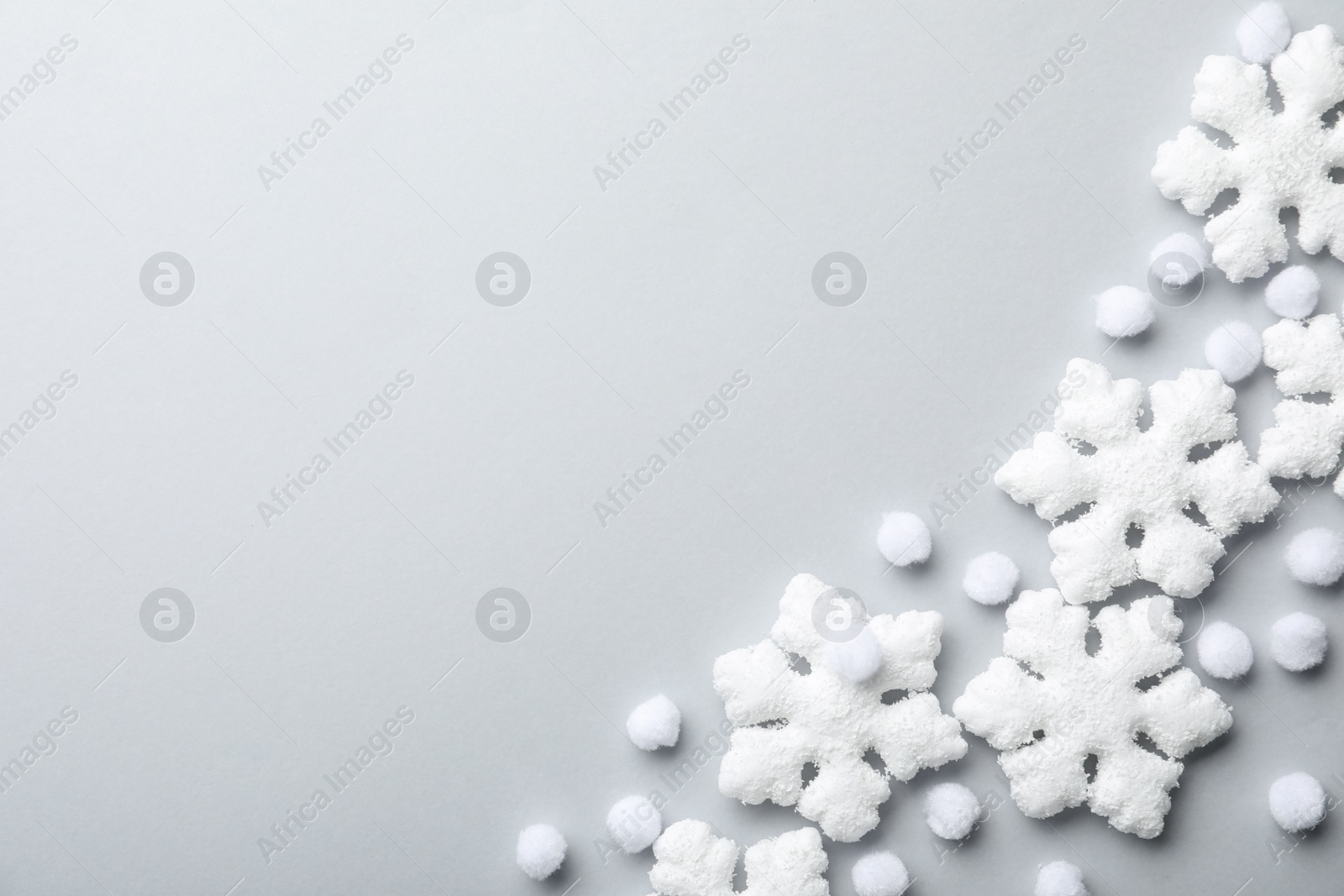 Beautiful snowflakes and decorative balls on white background, flat lay. Space for text Photo of Beautiful snowflakes and decorative balls on white background, flat lay. Space for text