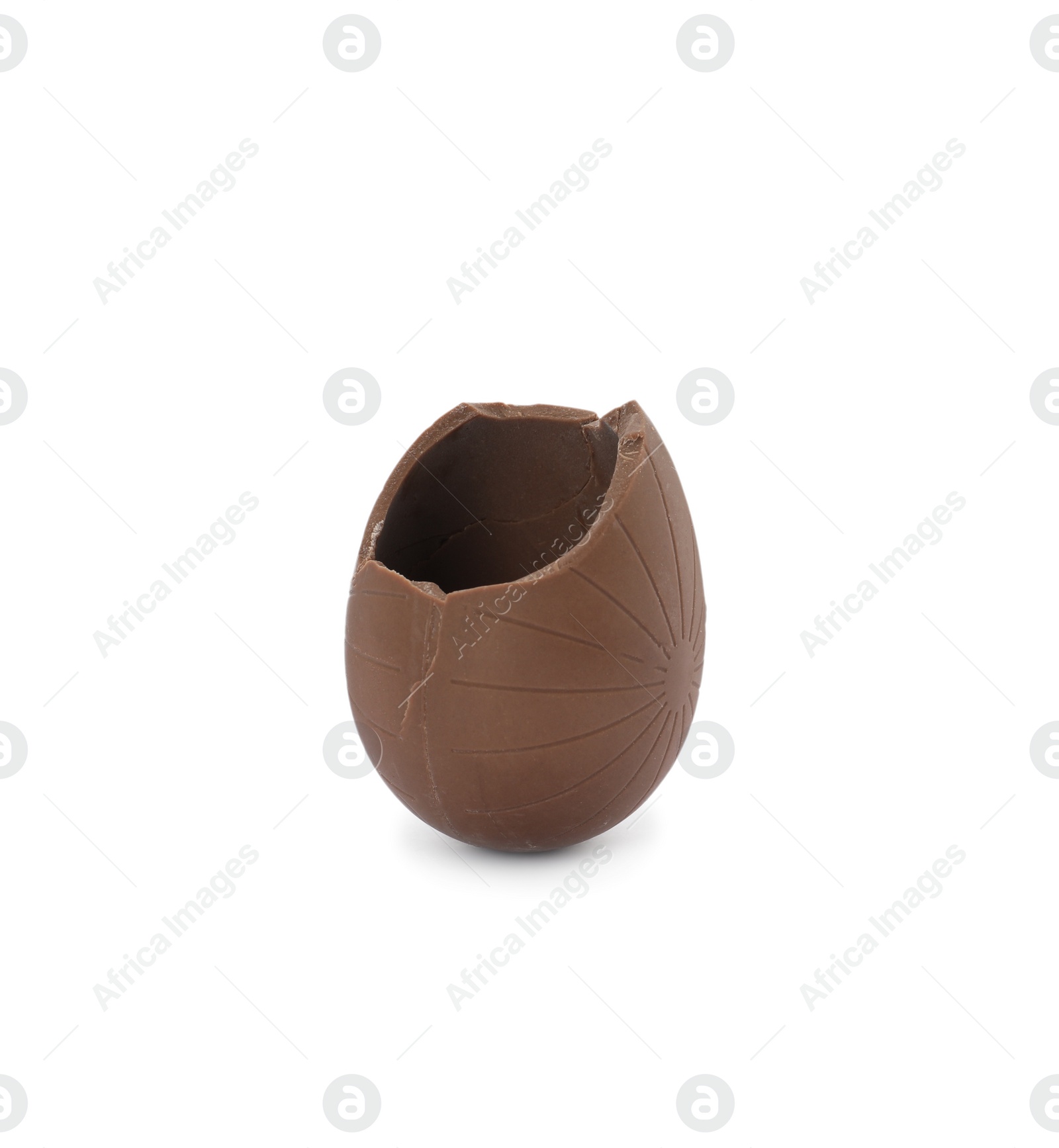 Broken milk chocolate egg on white background Photo of Broken milk chocolate egg on white background