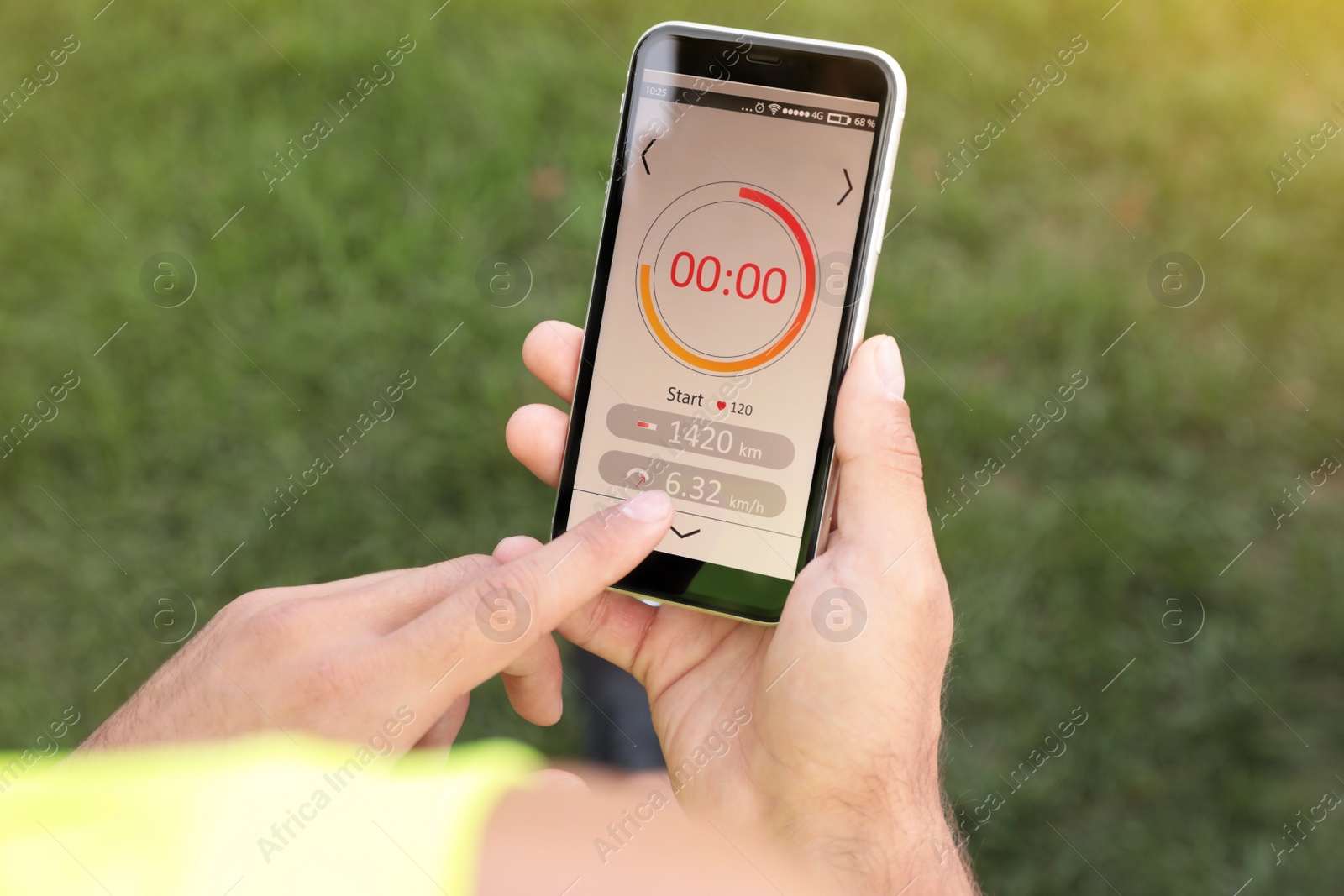 Photo of Man using fitness app on smartphone outdoors, top view