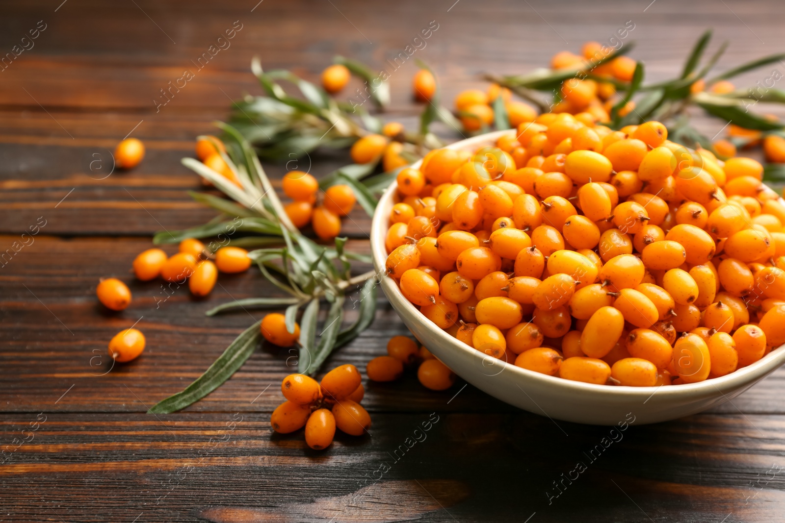 Fresh ripe sea buckthorn on wooden table. Space for text Photo of Fresh ripe sea buckthorn on wooden table. Space for text