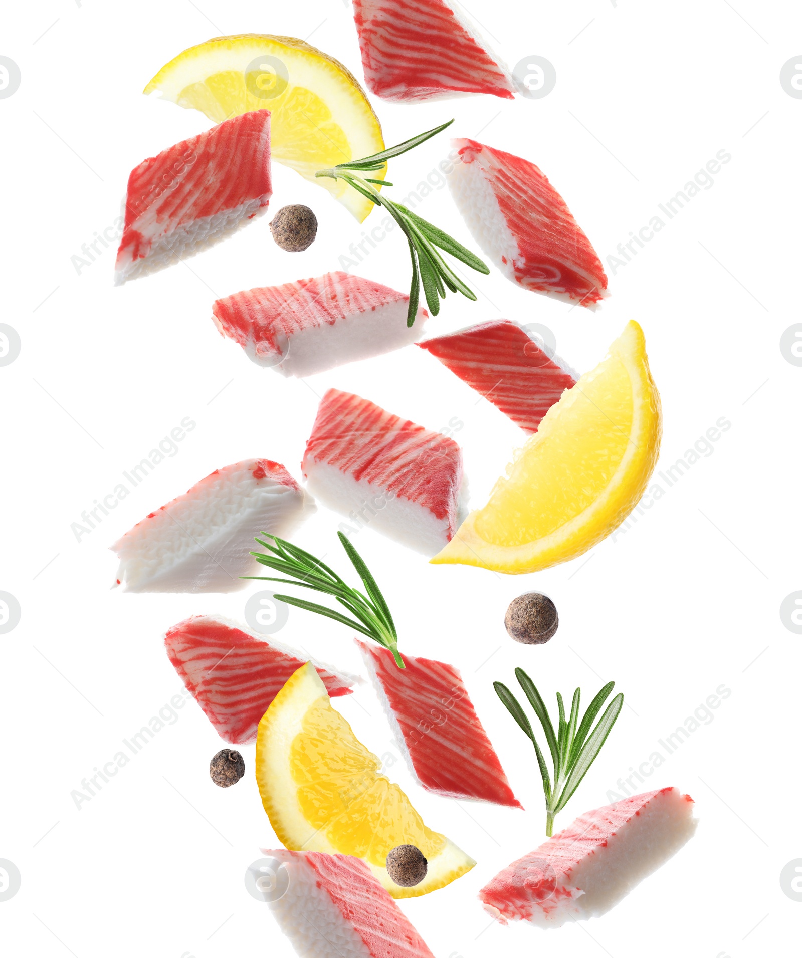 Cut fresh crab sticks, lemon, rosemary and allspice falling on white background Image of Cut fresh crab sticks, lemon, rosemary and allspice falling on white background
