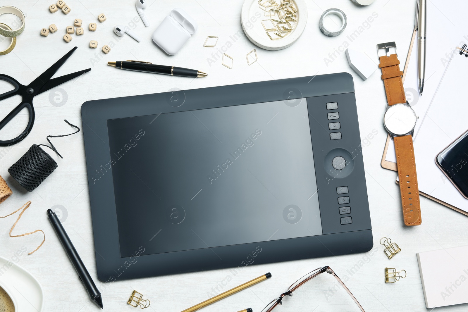 Flat lay composition with graphics tablet, stationery and accessories on white table. Designer's workplace Photo of Flat lay composition with graphics tablet, stationery and accessories on white table. Designer's workplace