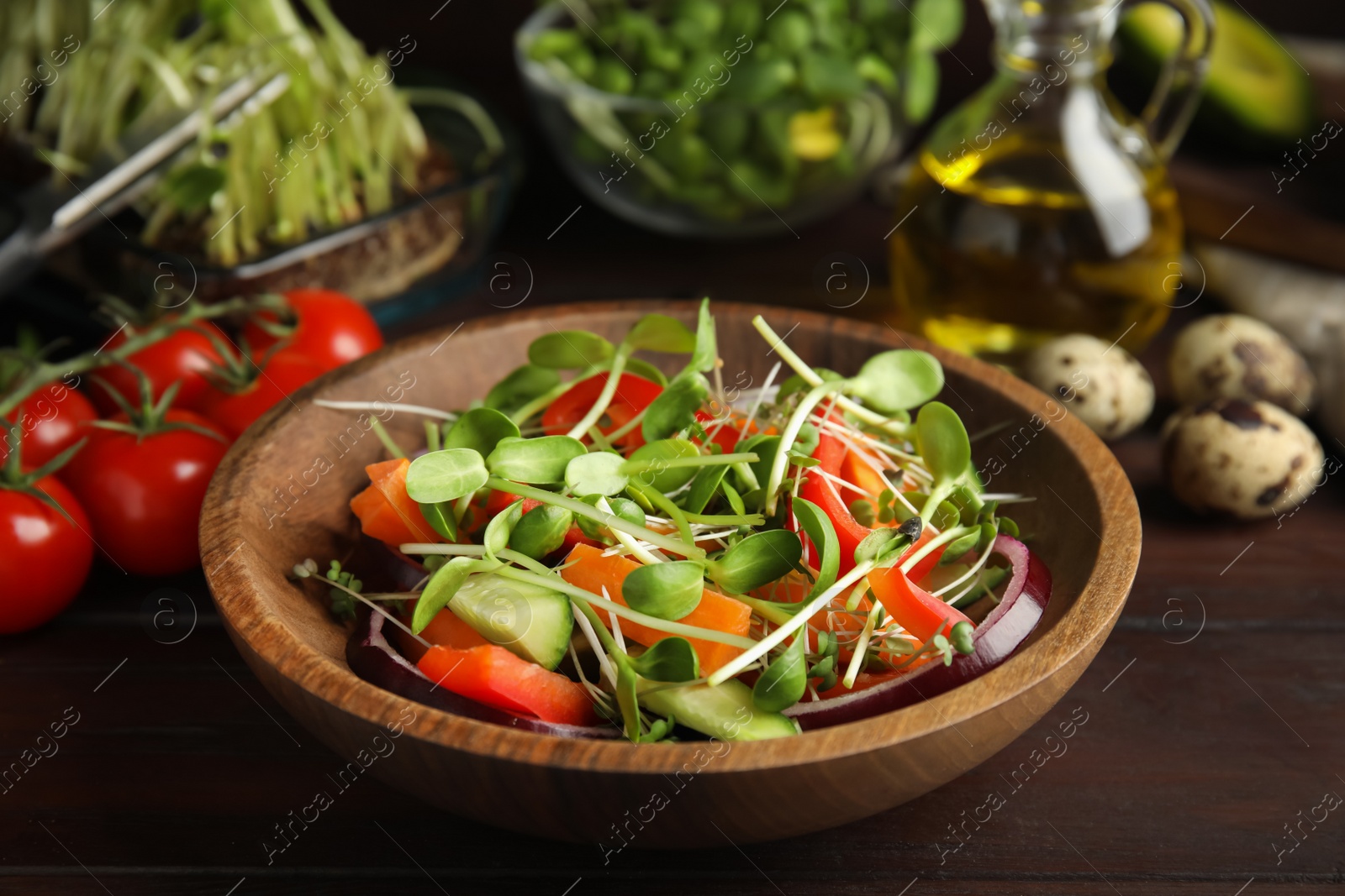 Salad with fresh organic microgreen in bowl on wooden table, closeup Photo of Salad with fresh organic microgreen in bowl on wooden table, closeup