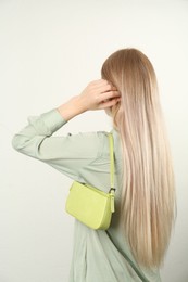 Woman with stylish baguette handbag on white background Photo of Woman with stylish baguette handbag on white background