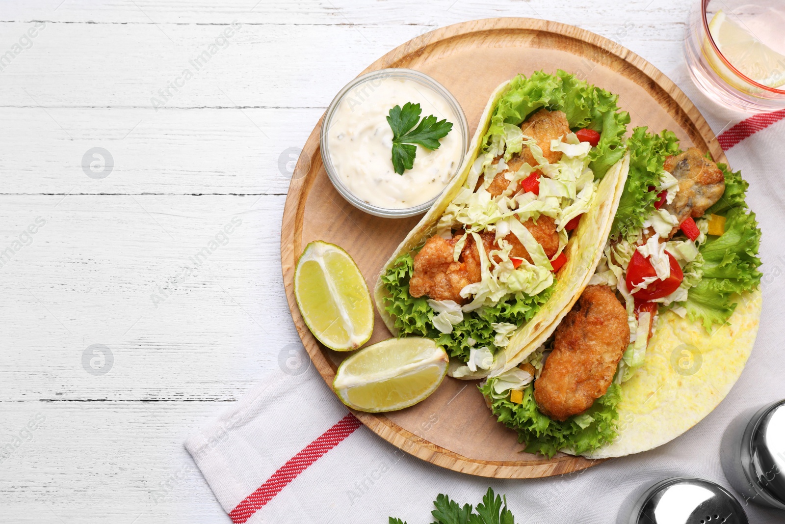 Delicious fish tacos served on white wooden table, flat lay Photo of Delicious fish tacos served on white wooden table, flat lay