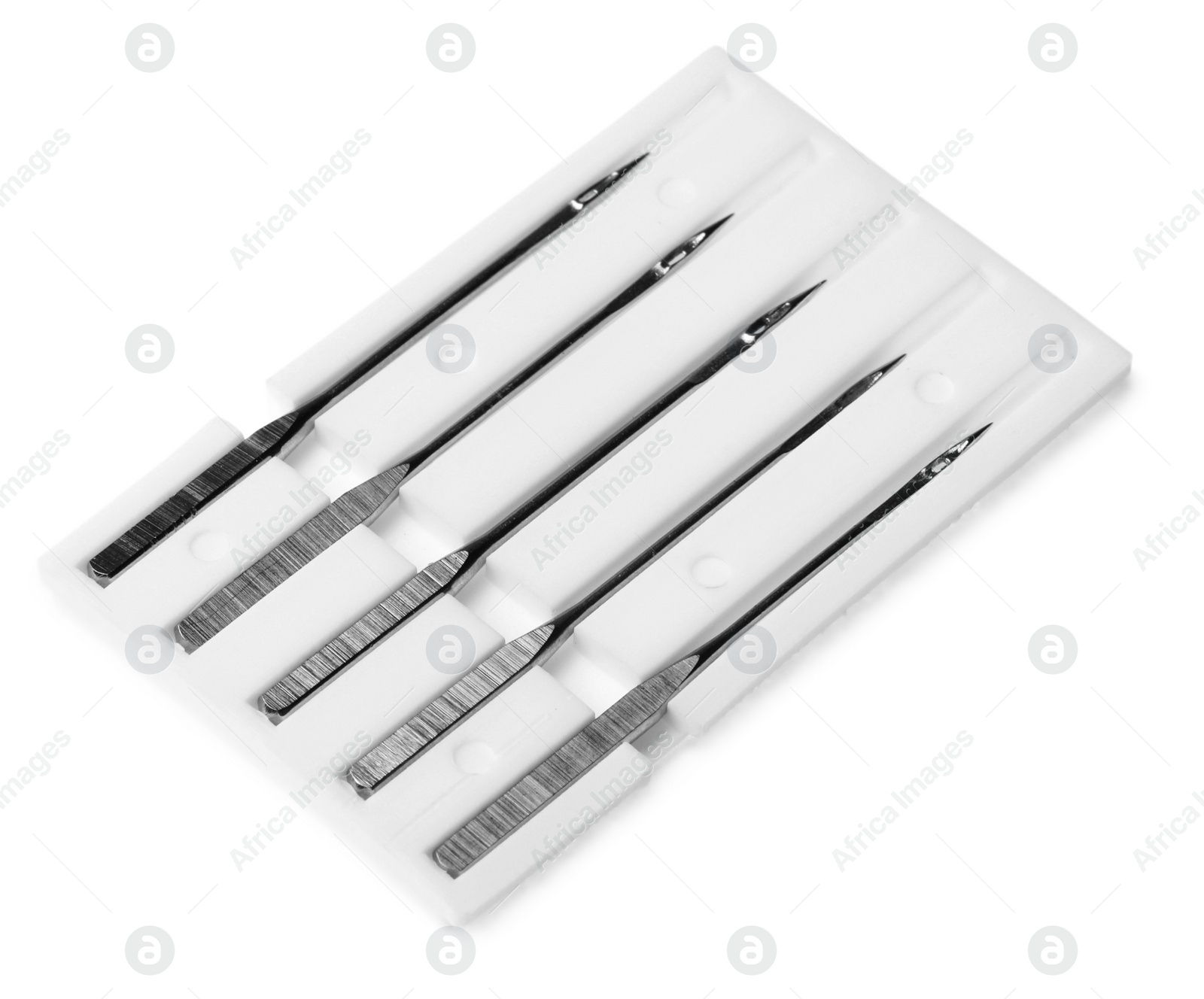 Photo of Set of sewing machine needles with package isolated on white