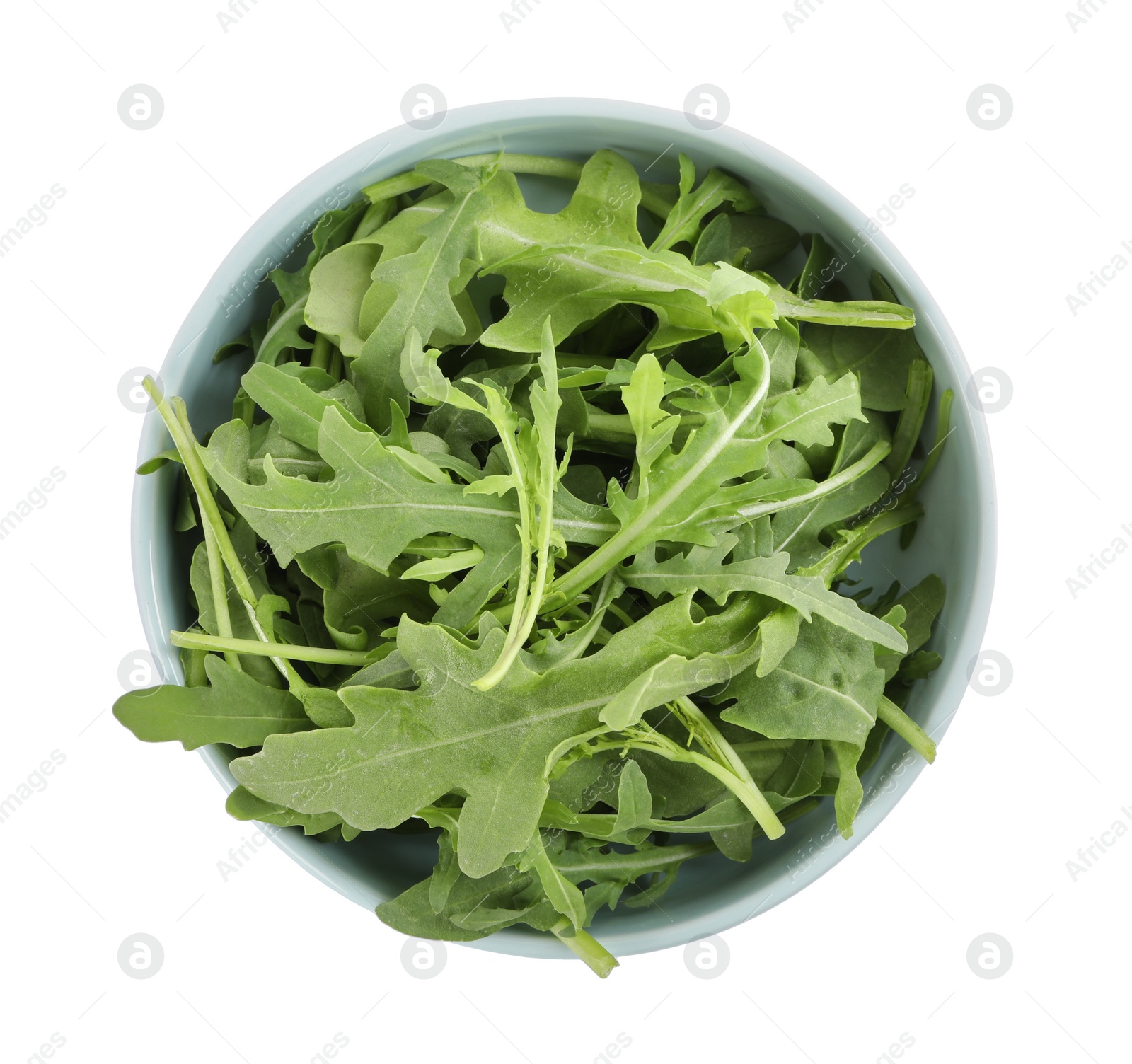 Delicious fresh arugula in bowl isolated on white, top view Photo of Delicious fresh arugula in bowl isolated on white, top view