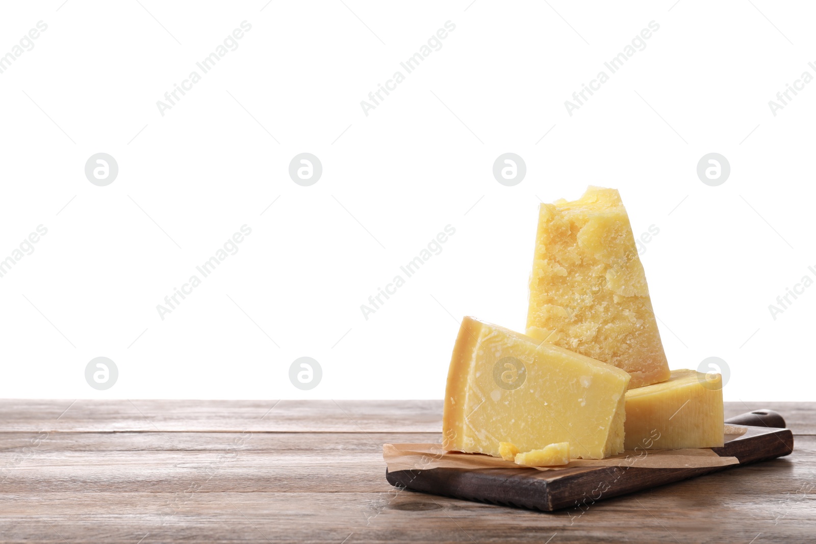 Pieces of delicious parmesan cheese on wooden table against white background. Space for text Photo of Pieces of delicious parmesan cheese on wooden table against white background. Space for text