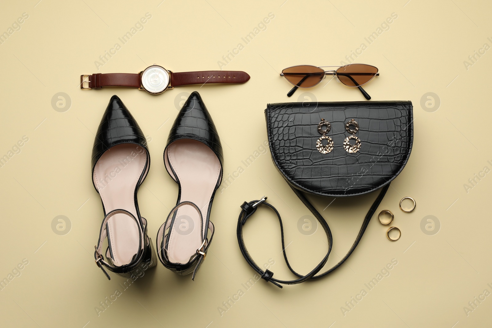 Stylish woman's bag, shoes and accessories on beige background, flat lay Photo of Stylish woman's bag, shoes and accessories on beige background, flat lay