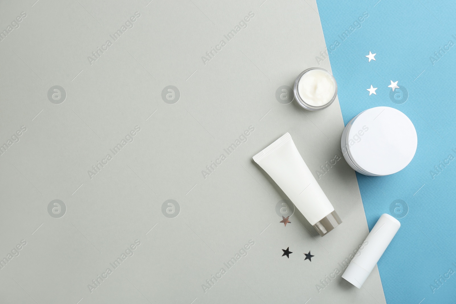 Flat lay composition with different cosmetic products on color background, space for text. Winter care Photo of Flat lay composition with different cosmetic products on color background, space for text. Winter care
