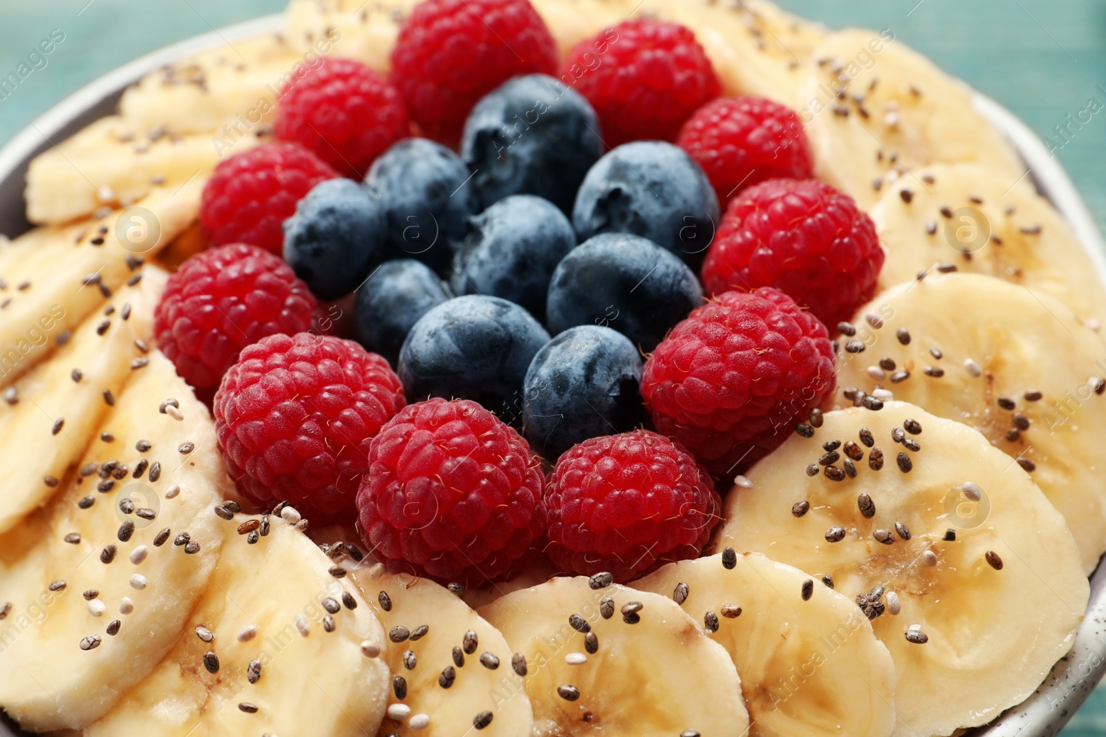 Tasty breakfast dish with berries, banana and chia seeds, closeup Photo of Tasty breakfast dish with berries, banana and chia seeds, closeup