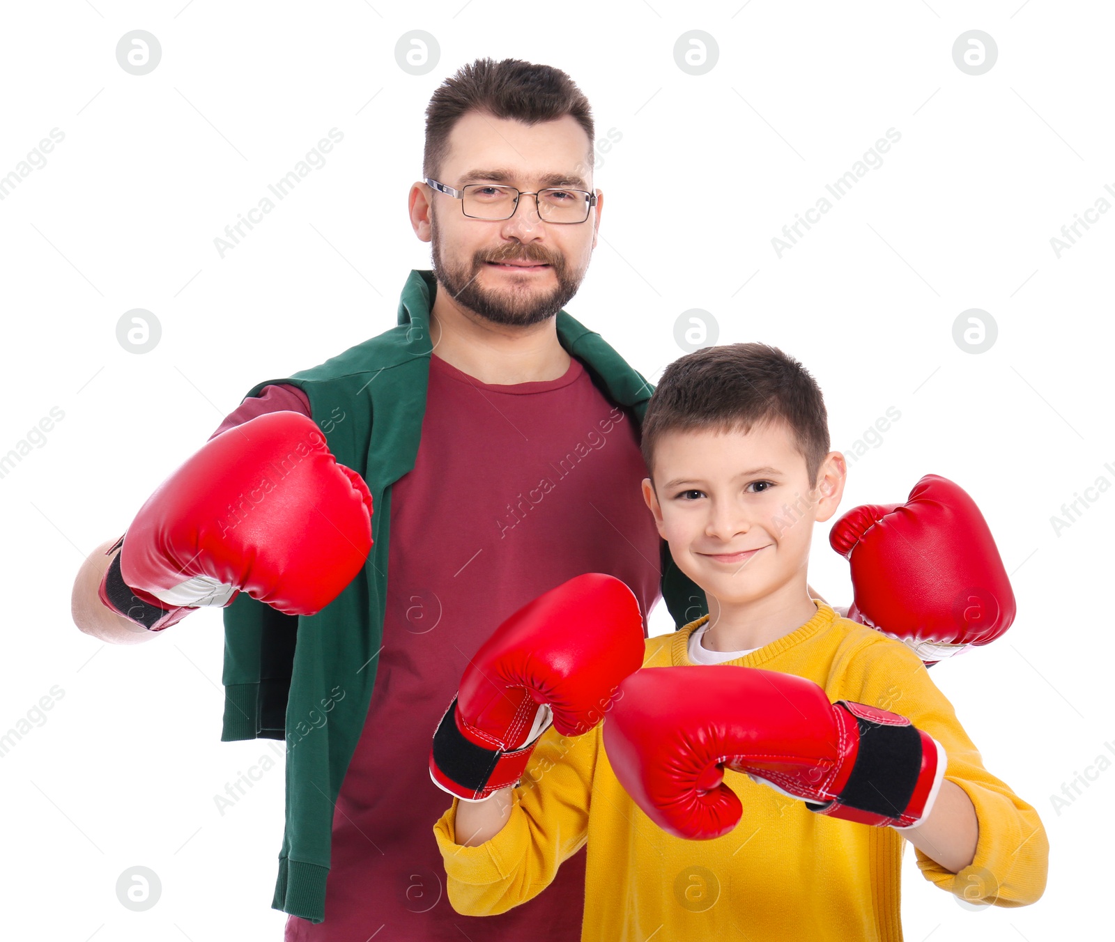 Photo of Little boy and his dad in boxing gloves on white background