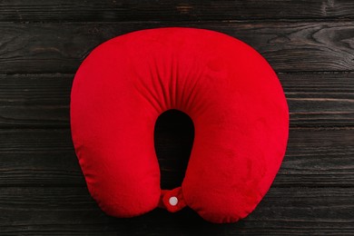 Red travel pillow on wooden background, top view Image of Red travel pillow on wooden background, top view