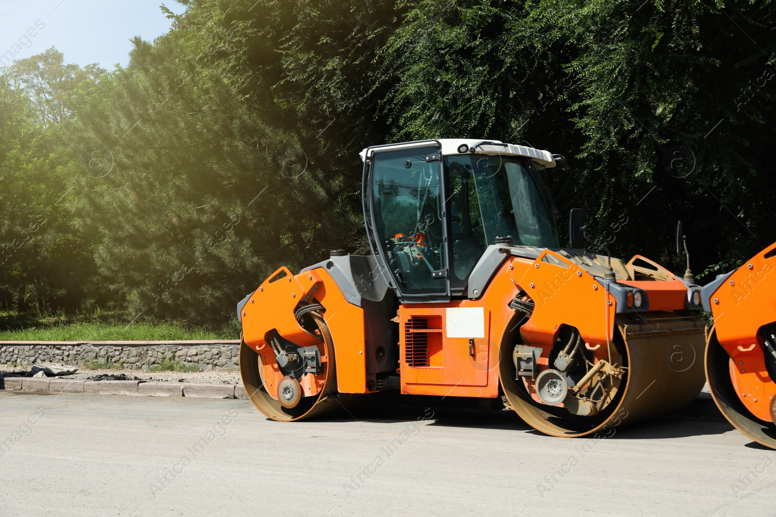 Modern roller on city street. Road repair service Photo of Modern roller on city street. Road repair service