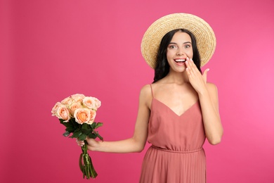 Portrait of emotional woman with beautiful bouquet on pink background Photo of Portrait of emotional woman with beautiful bouquet on pink background