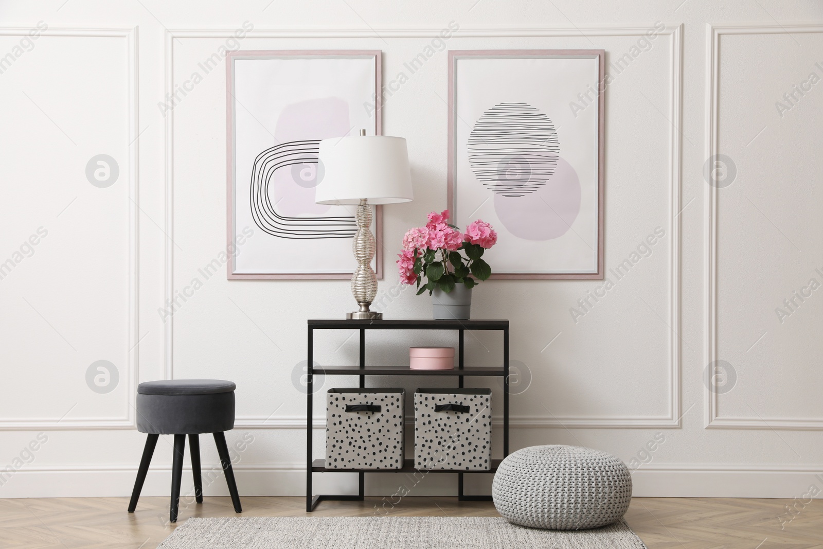 Console table with beautiful hydrangea flower and lamp near white wall in hallway. Interior design Photo of Console table with beautiful hydrangea flower and lamp near white wall in hallway. Interior design
