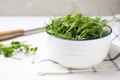 Bowl with fresh microgreen on white table, closeup Photo of Bowl with fresh microgreen on white table, closeup