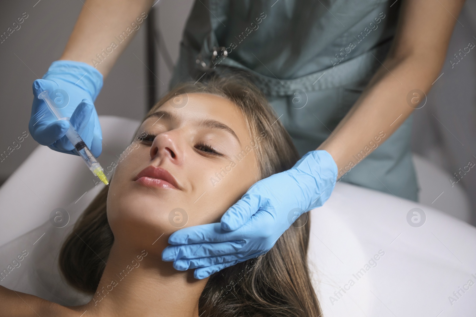 Beautiful woman getting facial injection in salon Photo of Beautiful woman getting facial injection in salon
