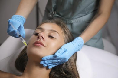 Beautiful woman getting facial injection in salon Photo of Beautiful woman getting facial injection in salon