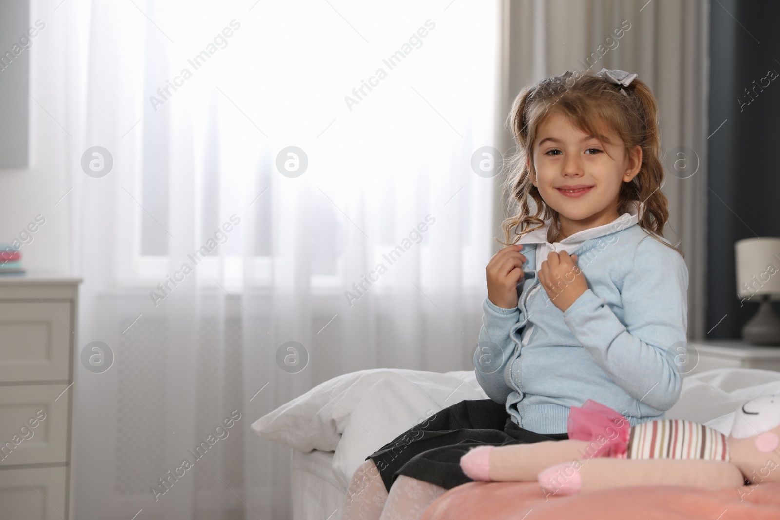 Little girl getting ready for school in bedroom Photo of Little girl getting ready for school in bedroom