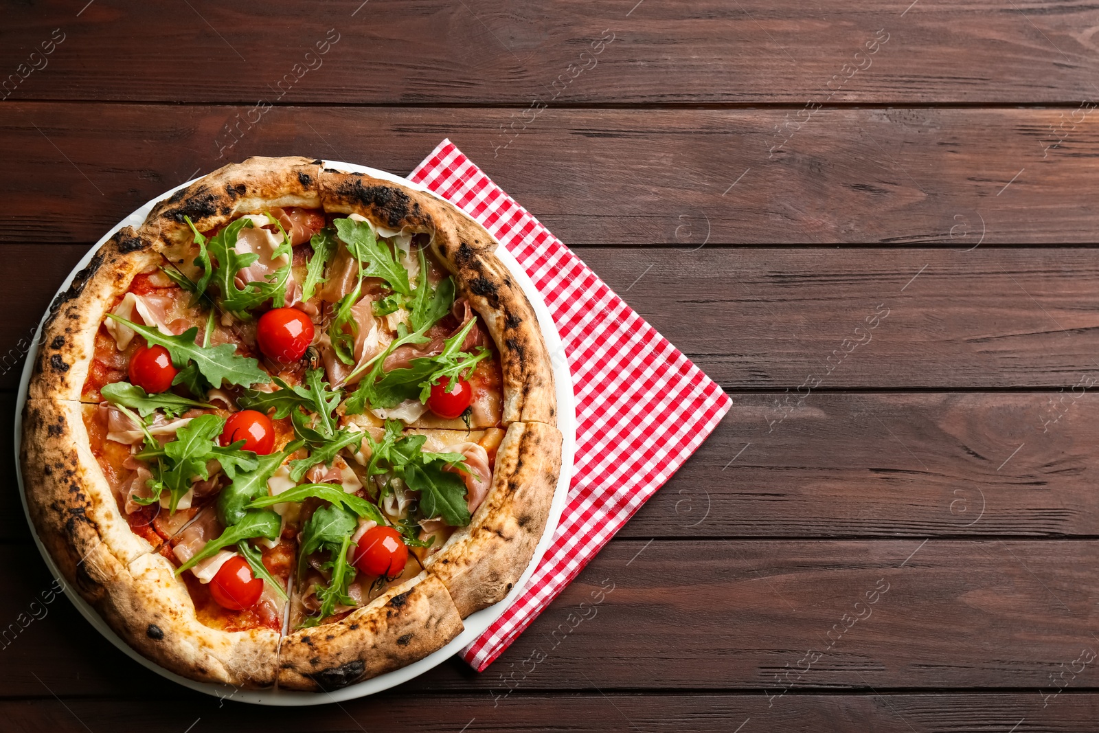 Tasty pizza with meat and arugula on wooden table, top view. Space for text Photo of Tasty pizza with meat and arugula on wooden table, top view. Space for text