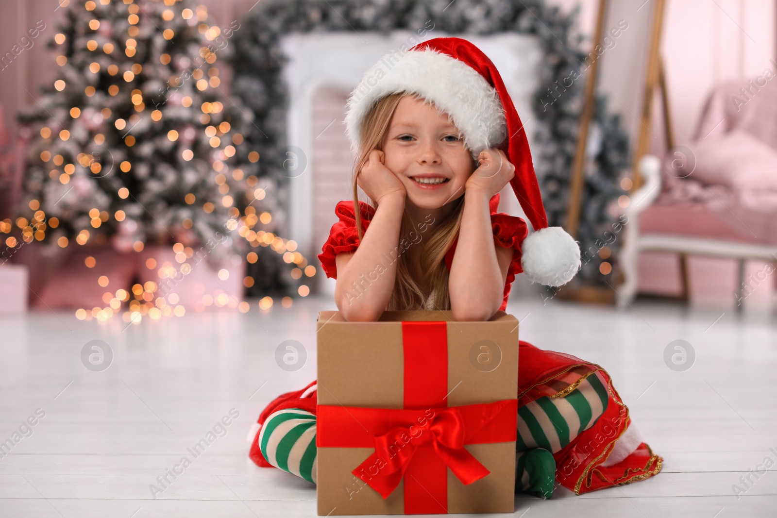 Cute little child with Christmas gift at home Photo of Cute little child with Christmas gift at home