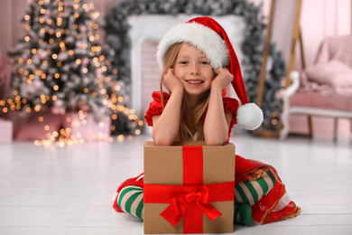 Cute little child with Christmas gift at home Photo of Cute little child with Christmas gift at home