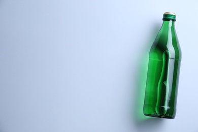 Glass bottle with water on white background, top view. Space for text Photo of Glass bottle with water on white background, top view. Space for text