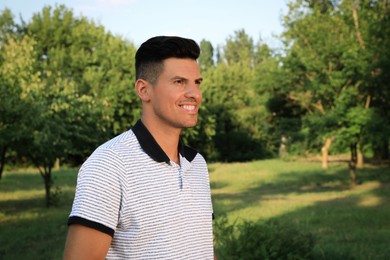 Handsome man in park on sunny day Photo of Handsome man in park on sunny day