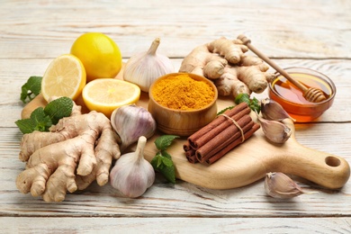 Photo of Different fresh products on light wooden table. Natural antibiotics