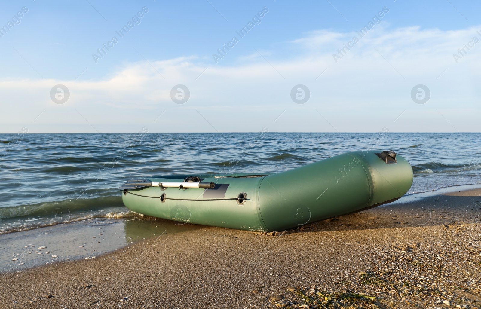 Inflatable rubber fishing boat on sandy beach near sea Photo of Inflatable rubber fishing boat on sandy beach near sea