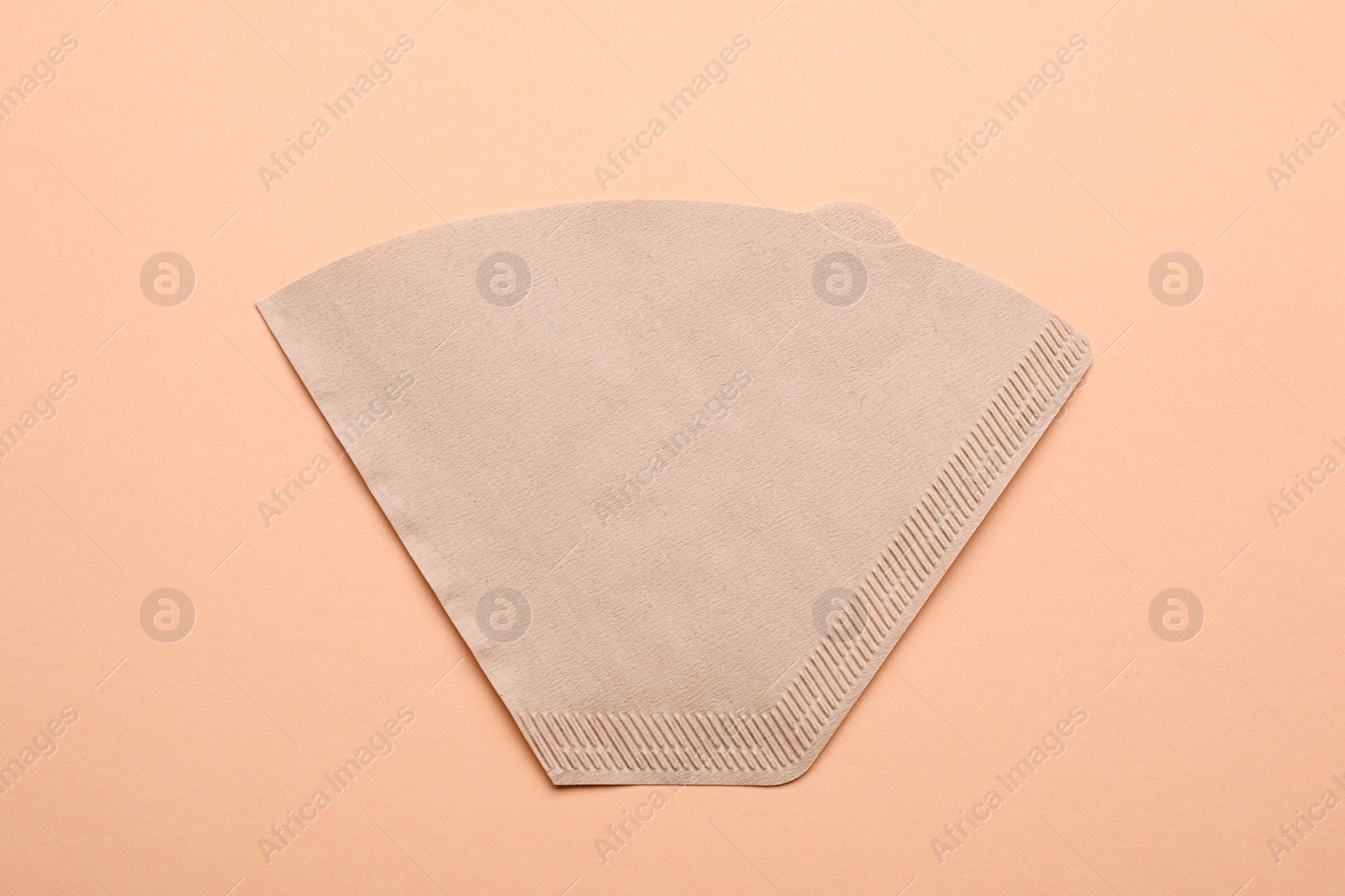 Paper coffee filter on beige background, top view Photo of Paper coffee filter on beige background, top view
