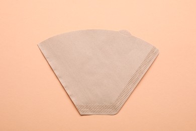 Paper coffee filter on beige background, top view Photo of Paper coffee filter on beige background, top view