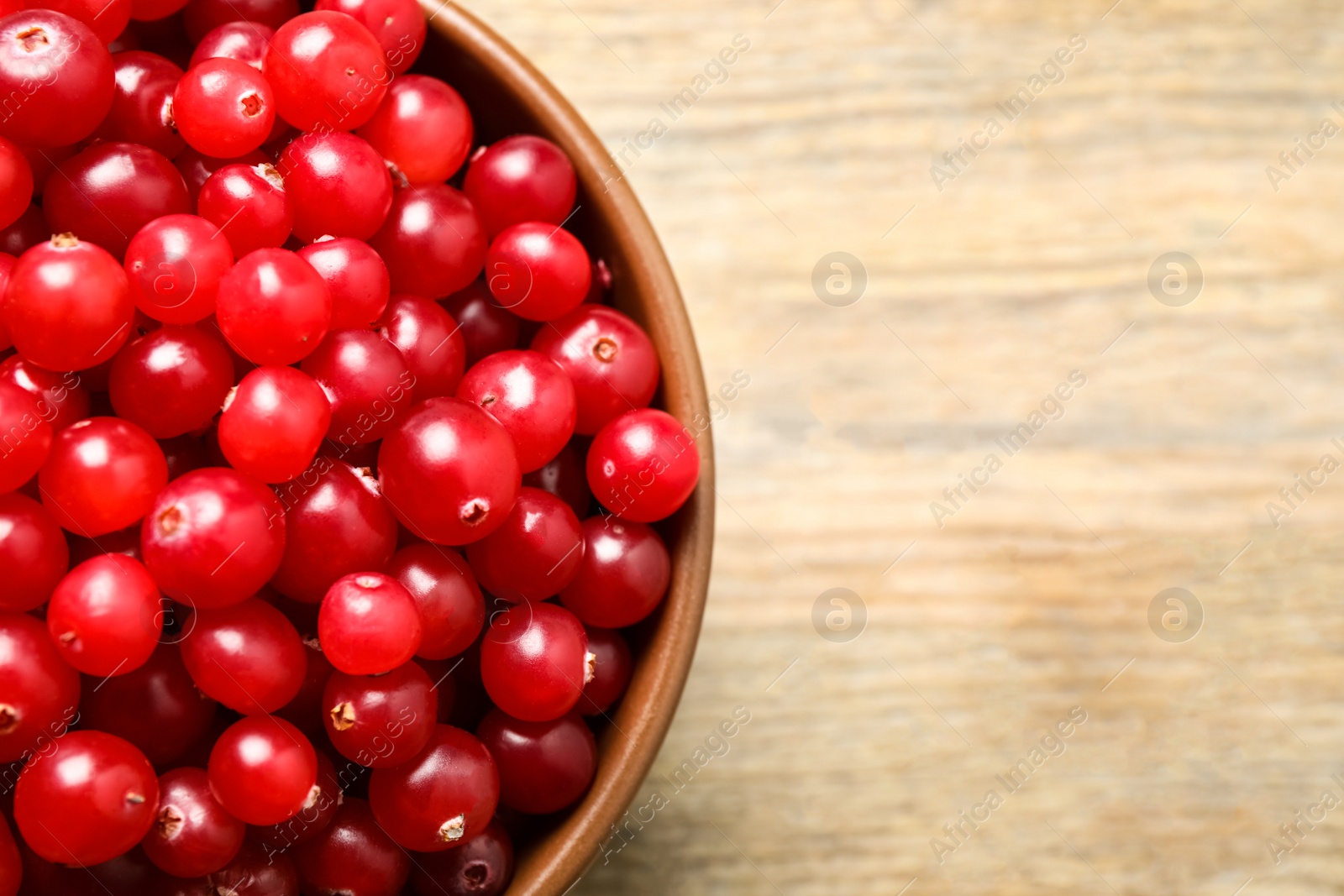Tasty ripe cranberries on wooden table, top view. Space for text Photo of Tasty ripe cranberries on wooden table, top view. Space for text