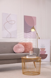 Stylish living room interior with comfortable sofa and beautiful pictures Photo of Stylish living room interior with comfortable sofa and beautiful pictures