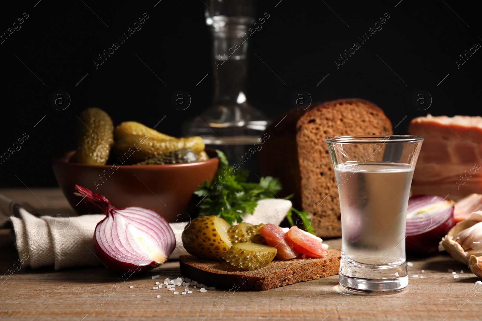 Cold Russian vodka with snacks on wooden table Photo of Cold Russian vodka with snacks on wooden table