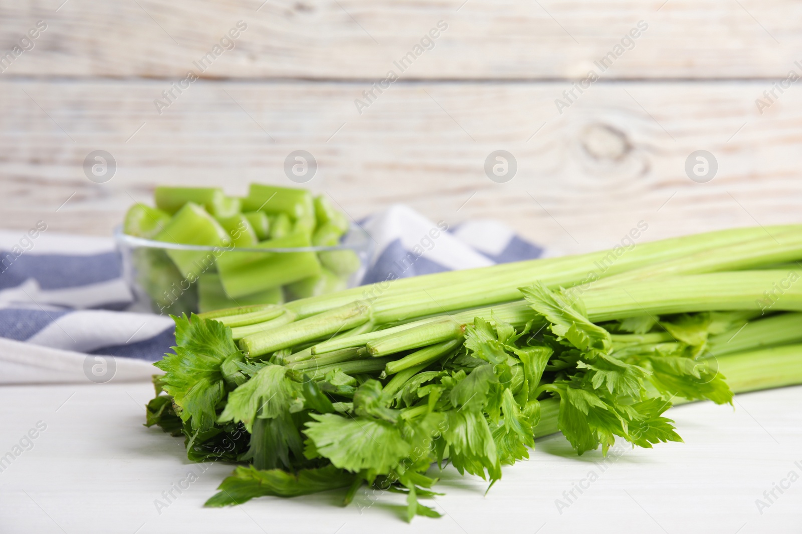 Fresh ripe green celery on white wooden table, closeup. Space for text Photo of Fresh ripe green celery on white wooden table, closeup. Space for text