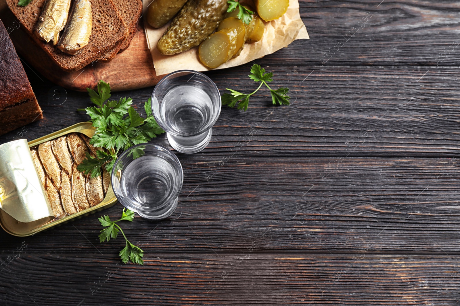 Flat lay composition with cold Russian vodka on black wooden table, space for text Photo of Flat lay composition with cold Russian vodka on black wooden table, space for text