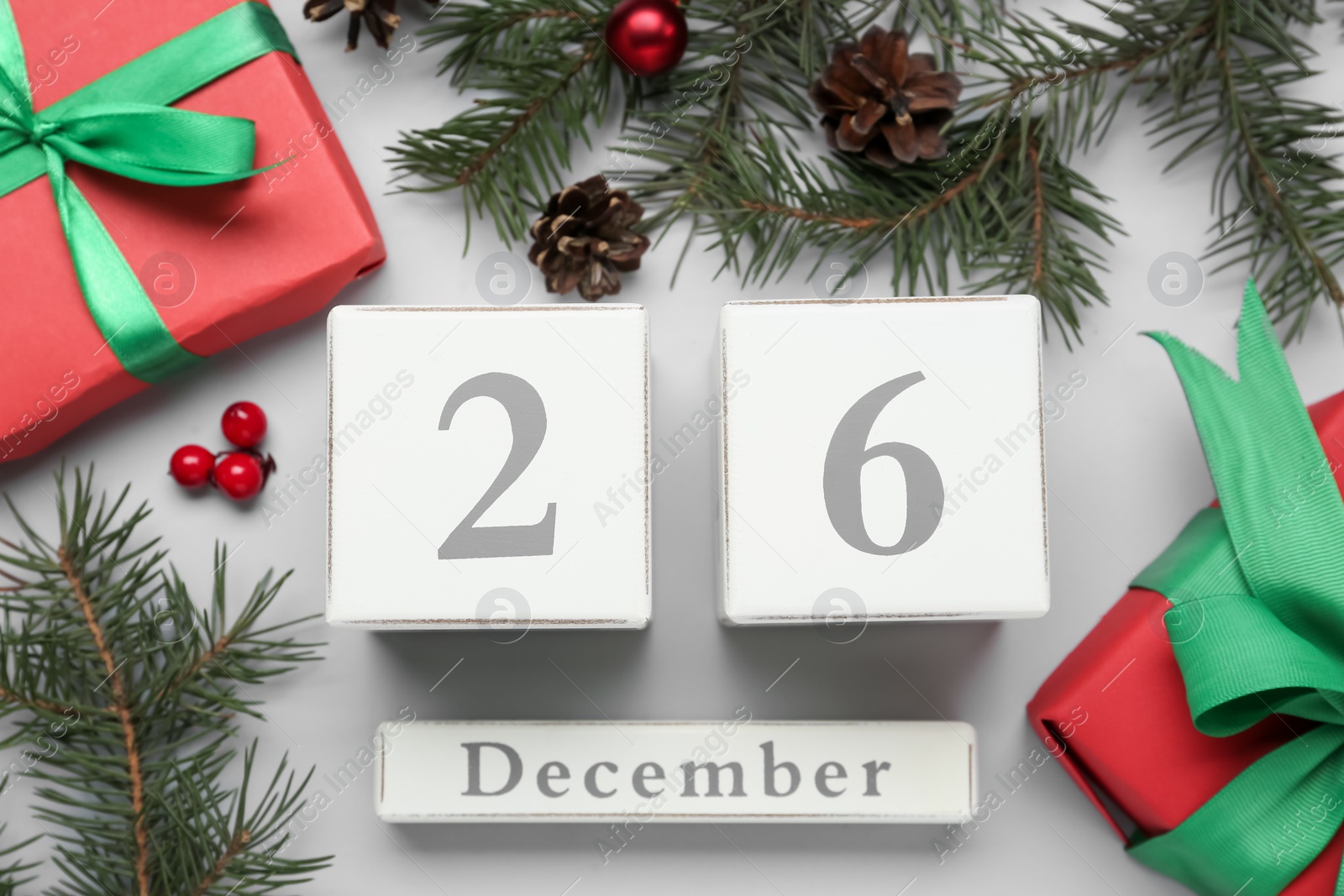 Flat lay composition with block calendar and gifts on white background. Boxing day concept Photo of Flat lay composition with block calendar and gifts on white background. Boxing day concept