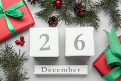 Flat lay composition with block calendar and gifts on white background. Boxing day concept Photo of Flat lay composition with block calendar and gifts on white background. Boxing day concept