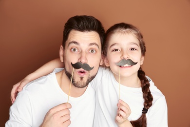 Dad and his daughter having fun on color background. Father's day celebration Photo of Dad and his daughter having fun on color background. Father's day celebration