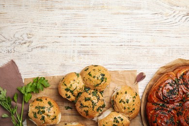 Traditional Ukrainian bread (Pampushky) with garlic on white wooden table, flat lay. Space for text Photo of Traditional Ukrainian bread (Pampushky) with garlic on white wooden table, flat lay. Space for text