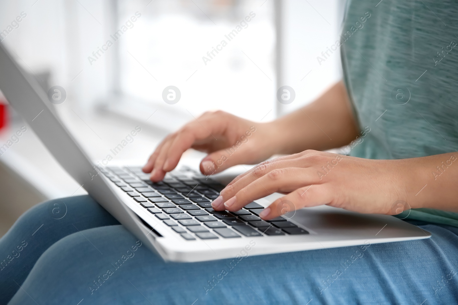 Young woman using laptop indoors, closeup Photo of Young woman using laptop indoors, closeup