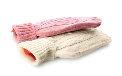 Photo of Hot water bottles with knitted covers isolated on white