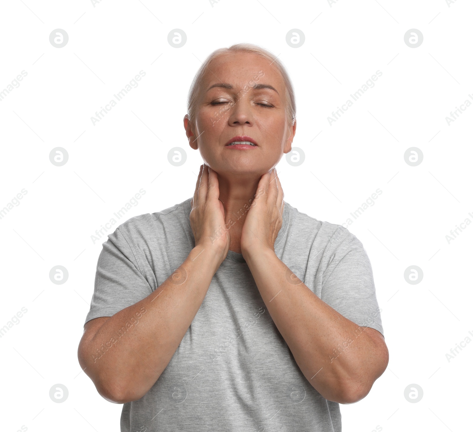 Photo of Mature woman doing thyroid self examination on white background