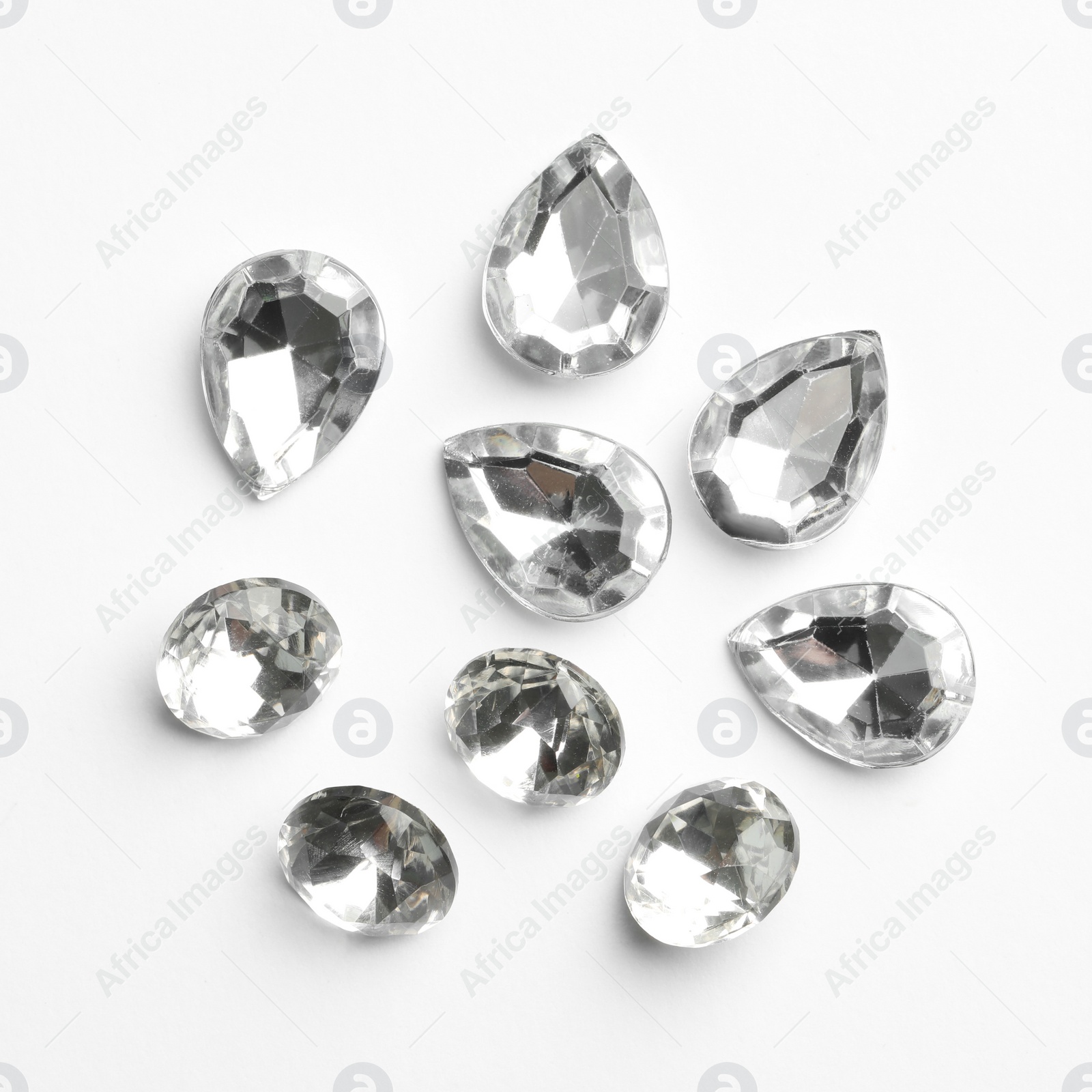 Different beautiful gemstones on white background, top view Image of Different beautiful gemstones on white background, top view