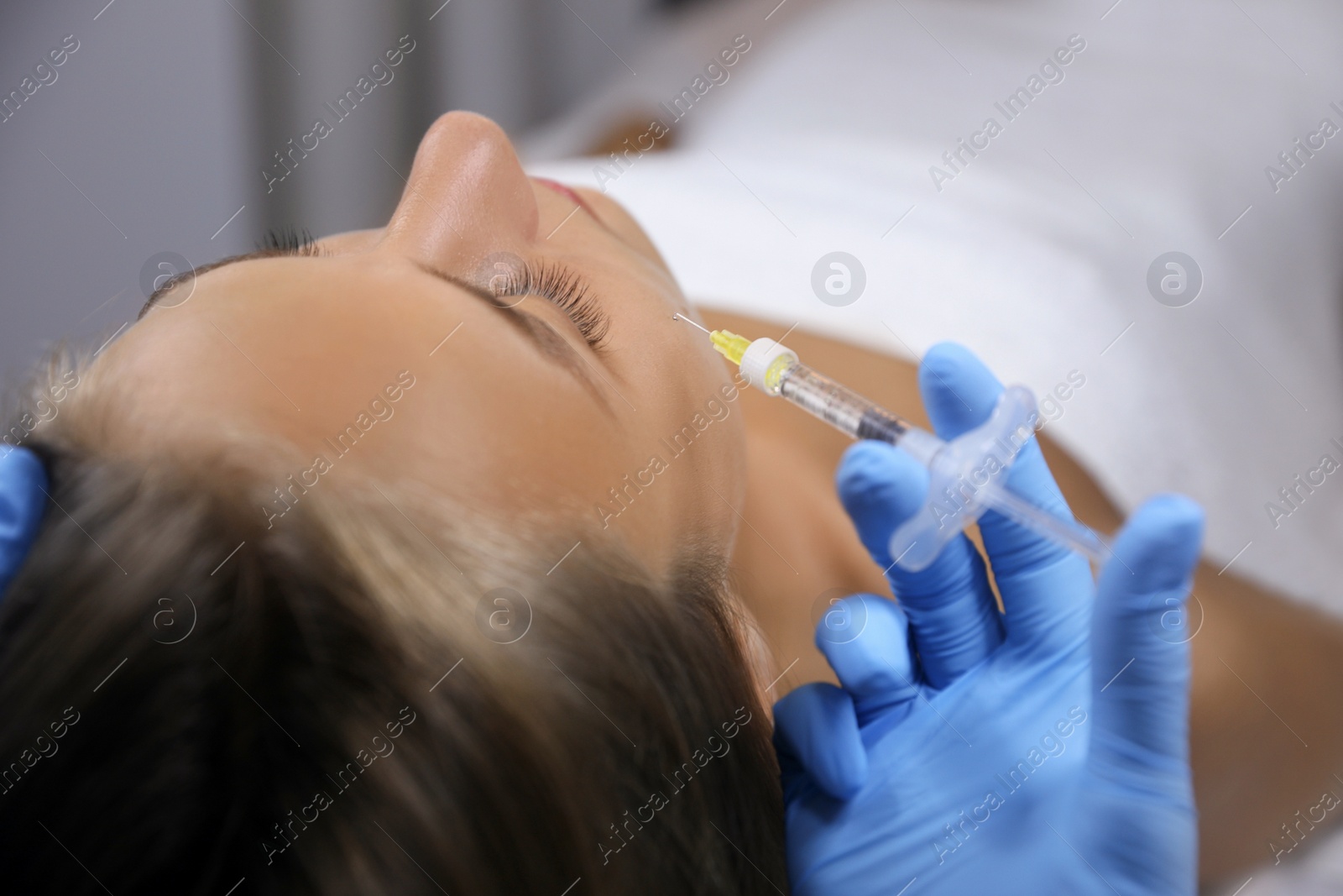 Beautiful woman getting facial injection in salon Photo of Beautiful woman getting facial injection in salon