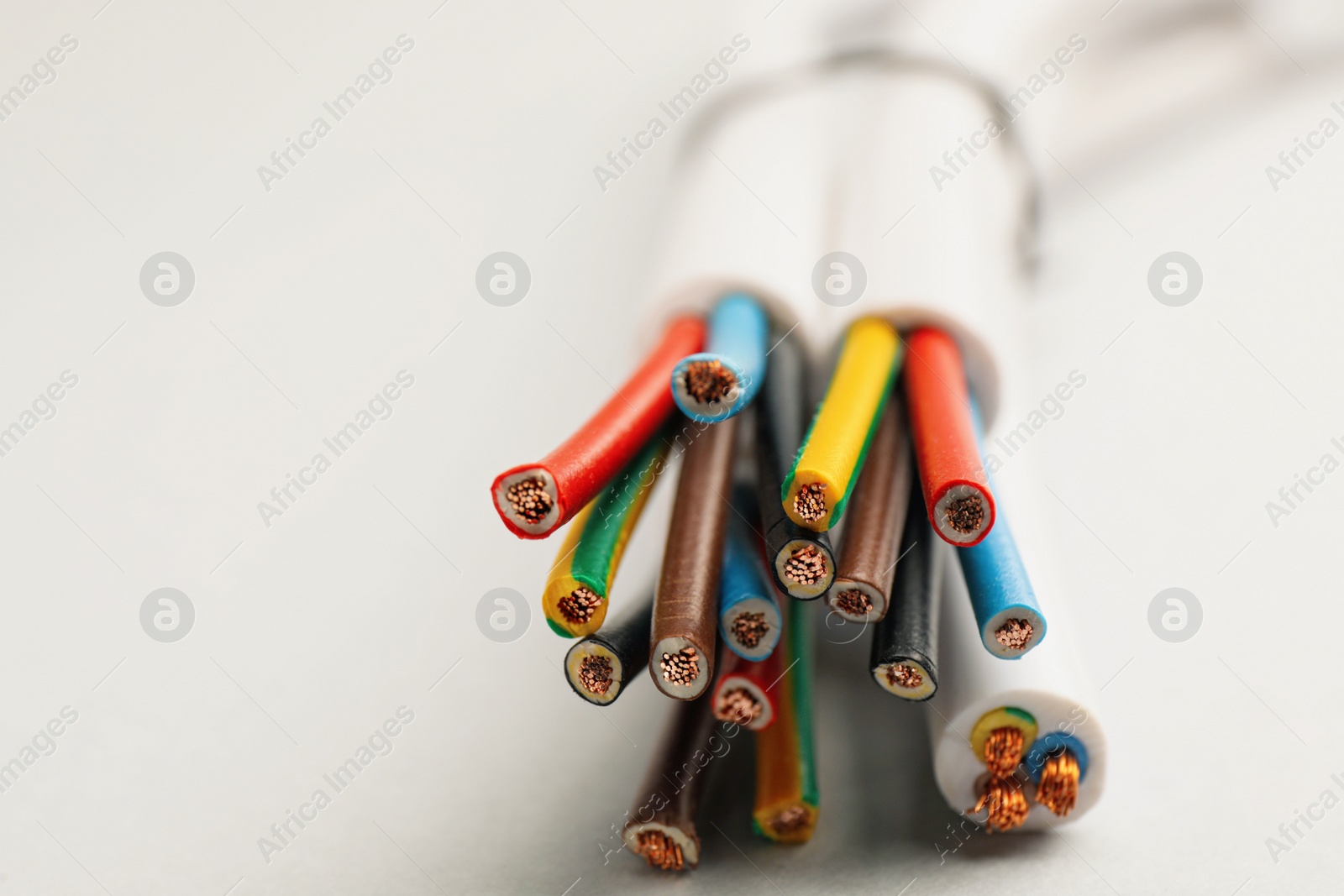 Cables with wires on light background, closeup Photo of Cables with wires on light background, closeup